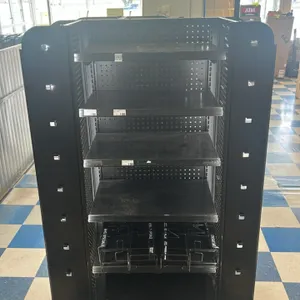 Portable candy and magazine display rack. Features black metal construction with a multi-sided layout. Equipped with adjustable flat metal shelves, pe