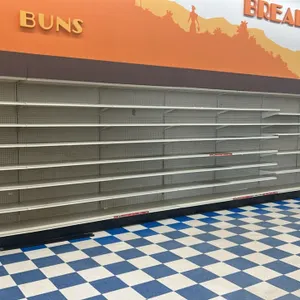 46'L of Lozier wall shelving. Features 84"H uprights, 19"D base shelves, pegboard backing, and adjustable upper shelves. Cream finish with black end p