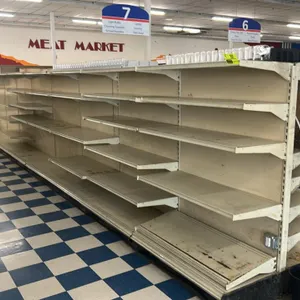 91'L of Lozier double-sided gondola shelving. Features 67"H uprights with 22"D base shelves and adjustable upper shelves. Cream finish with a mix of s