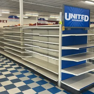 120'L of Lozier gondola shelving. Features 25"D base shelves and 84"H uprights. Includes adjustable upper metal shelving, select pegboard backing, and