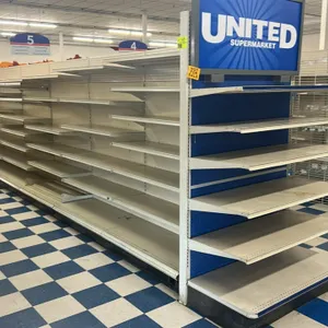 120'L of Lozier gondola shelving. 84"H uprights with 22"D base shelves. Features adjustable shelves, pegboard backing, and integrated price channels. 