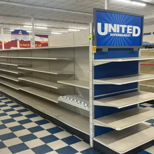 120'L of Lozier gondola shelving. Features 84"H uprights, 22"D base shelves, adjustable upper shelves, pegboard backings, and end cap signage. Content