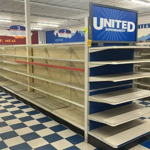 120'L of Lozier gondola shelving. Features 84"H uprights with 22"D base shelves. Includes adjustable metal and wire shelves with endcaps. Contents not