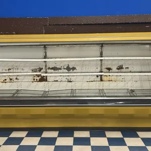Tyler 12'L multi-tier open display case. Features multi-shelf configuration with wire bottom decks and yellow exterior finish. 12'L. Note: shows heavy