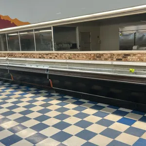 Tyler 40'L open grab and go merchandising case lineup. Consists of (2) 12'L and (2) 8'L connected sections. Features black exterior with woodgrain tri