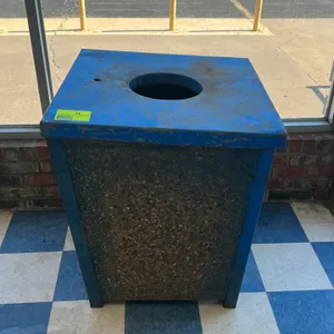 Stone panel trash can. Features decorative aggregate stone side panels with a blue painted metal frame. Includes a matching blue painted metal lid wit