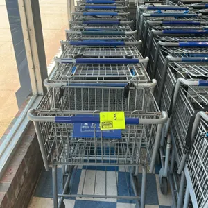 Metal wire shopping cart. Features a blue plastic handle grip, a folding child seat with a blue plastic seat back, an adjustable safety strap, and a l