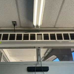 Dayton 4YP02B compact air curtain. Features a 1/8 HP motor and a white finish. Electrical: 120V, 60Hz, 1-Phase, 1.9 Max Amps. Ceiling/header mounted w
