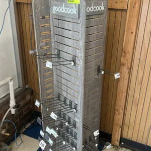Good Cook 4-sided spinning slatwall merchandiser. Features gray woodgrain laminate construction with 'goodcook' branded header panels on all four side