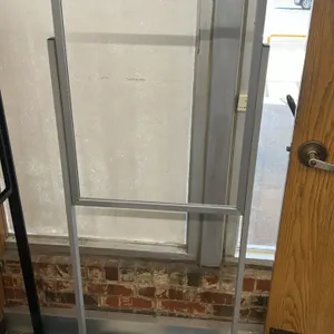 Metal sign stands. Lot includes one silver-toned metal stand and one black metal stand. Designed for holding rigid signs or poster inserts. Features r