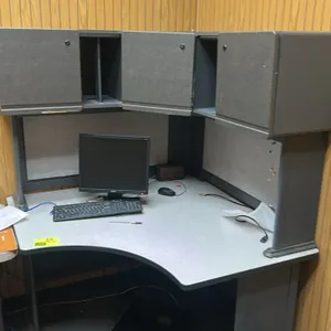 Laminate corner desk. Features a 4'x4' light gray laminate desktop with a curved front edge and gray metal support legs. Includes an upper storage hut