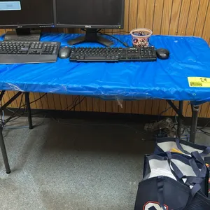 Polyethylene folding utility table. Features folding metal legs. 4'L x 2'W. Note: Monitors, keyboards, mice, UPS, bags, and all other contents shown a