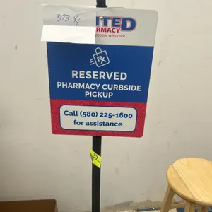 Portable poly sign stand. Features a black fillable plastic rolling base, black support pole, and a double-sided plastic sign reading 'Reserved Pharma