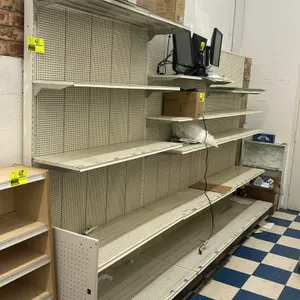 12'L of wall shelving. Composed of (3) 4'L sections with 22"D base shelves and pegboard backing. Height: 84"H. Includes adjustable upper shelves. Cont