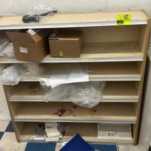 Multi-tier laminate shelving unit. Features woodgrain exterior side panels, a light laminate interior, and integrated price tag channels on the shelf 