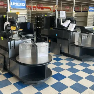 Stainless steel and laminate single belt check lane. Features a motorized conveyor belt and a rotating bag stand with bagging racks. Constructed with 