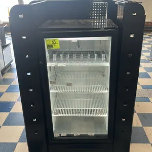 True mobile merchandising display unit. Features an integrated True single-door glass front cooler surrounded by a black metal candy and magazine rack
