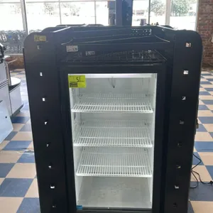 Portable candy and magazine display rack. Features multi-sided black metal construction with wire candy shelving, pegboard backing, and wire magazine 