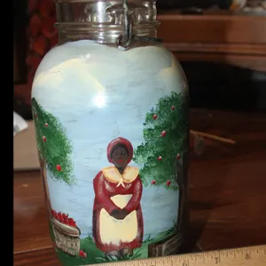Hand Painted Black Americana, Atlas E-Z Seal Jar With Lid, Depicting An Apple Orchard Scene With A Woman Picking Apples, Approximately 9 Inches Tall