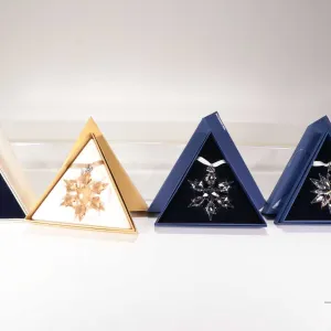 Four Swarovski Crystal collectible snowflakes including 1998, 2010 and 20th anniversary 2011 and SCS