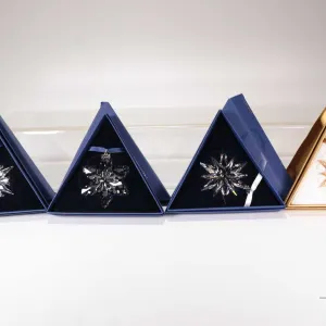 Four Swarovski Crystal collectible snowflakes including 2002, 2009, 2010 and 2011 20th anniversary