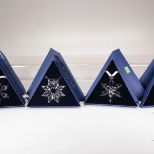 Four Swarovski Crystal collectible snowflakes including 2003, 2010, 2012 and 2015
