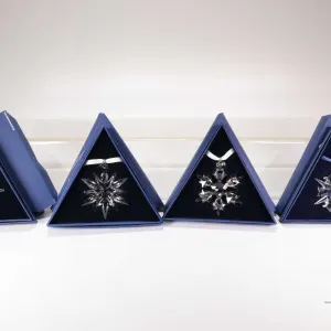 Four Swarovski Crystal collectible snowflakes including 1999, 2004, 2008 and SCS 2011
