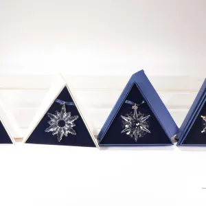 Four Swarovski Crystal collectible snowflakes including 1998, 2000, 2002 and 2006