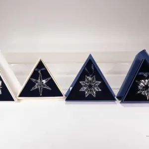 Four Swarovski Crystal collectible snowflakes including 1993, 1999, 2003 and 2007
