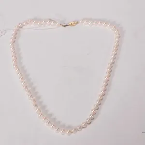 Strand of individually knotted genuine pearls with 14kt gold clasp, 18" in length