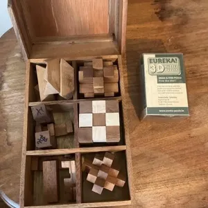 Wooden box of puzzles and snake and star puzzle