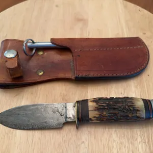 Sheffield, England Hunting knife with leather sheath and sharpener.