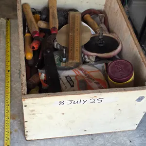 Wooden box full of tools and parts