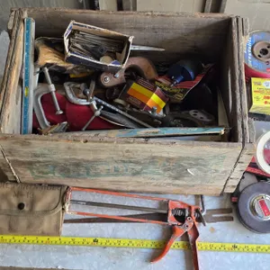 Wood crate with various tools and hardware