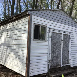 Building: 16’3” x 14’6” x approx 11’6” high at peak, door approx 6’ x 6’, partially insulated, shelving, vinyl siding, a few small holes, contents NOT