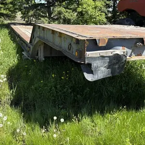 1980s low bed trailer, 8 1/2' wide, 35 ton, spring ride, tandem axle, NOT safetied, lights work, good for farm backroads use, see lot details