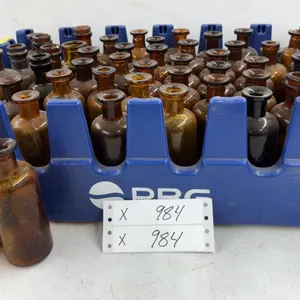 Small Amber Glass Bottles in Blue Crate