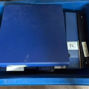 Recycling bin filled with assorted binders