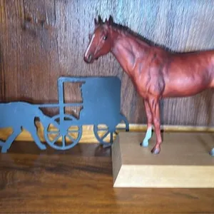 Horse figure with black outlined buggy and horse