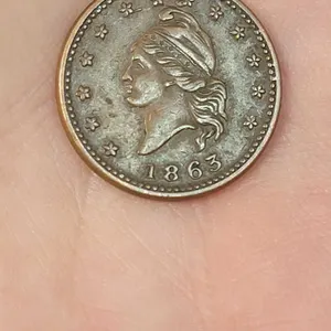 1863 CIVIL WAR TRADE TOKEN. 1863 on obverse and reverse boasts, "E. W. ATWOOD Dealer in BOOKS NEWSPAPERS & c" Copper token in very good co