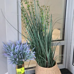 Assorted decor and utility lot. Includes three tall artificial potted grass plants, two faux lavender arrangements in gold-tone metal cylindrical vase