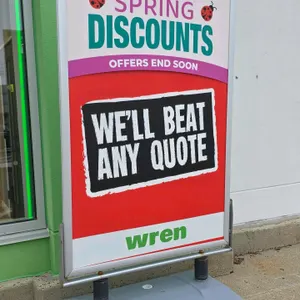 Outdoor portable dual-sided sign stand. Features a silver-tone aluminum snap frame mounted on a gray water-fillable plastic base with dual spring-load