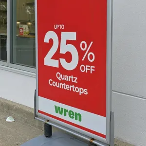 Outdoor portable dual-sided sign. Features an aluminum frame and a gray molded poly base. Dual heavy-duty spring mounts provide wind resistance. Desig