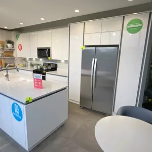 Wren Kitchens Infinity Plus kitchen cabinet and countertop display in Milano Ultra Bianco Gloss. Features Rhino Quartz countertops, double-bowl underm