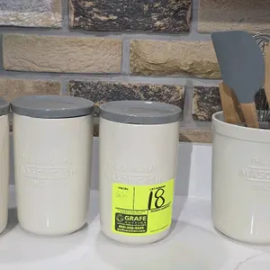 Mason Cash 2008.181 ceramic canister and utensil jar set. Includes (3) lidded canisters and (1) utensil crock. Features cream ceramic bodies embossed 