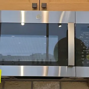 2023 GE JVM6175SK6SS over-the-range microwave oven. Features stainless steel exterior, glass turntable platter, touch control panel, integrated vent f