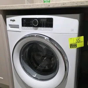 Whirlpool WFW5090JW 0 front-load washer. Features a glass door, stainless steel drum, digital control panel, and slide-out detergent dispenser. Electr