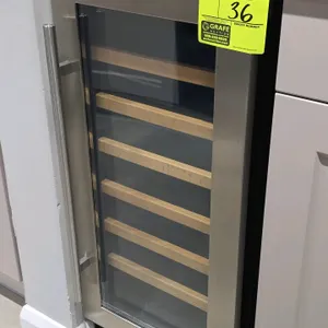 Whirlpool WUW35X15DS02 self-contained glass door wine cellar. Features stainless steel trimmed glass door, 6 slide-out racks with wood fronts, and dig