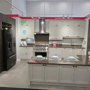 Wren Kitchens Infinity Plus cabinet set in Elements Velum Bronze Gloss and Shaker styles. Includes quartz countertops, stainless steel sink, and fauce