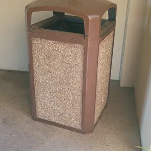 Outdoor trash can assortment. Includes a stone aggregate panel trash can with a brown dome lid measuring 26"x46", a black fluted plastic trash can, an